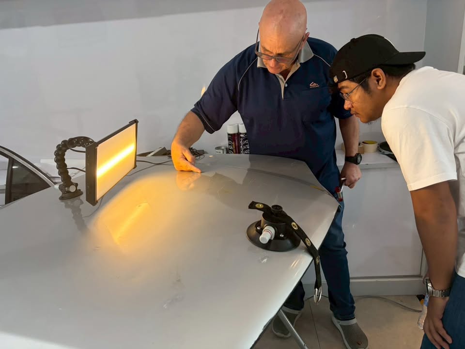 M&H Group instructor guides Adrian through dent analysis under a PDR reflection light - 14 July 2026 Training