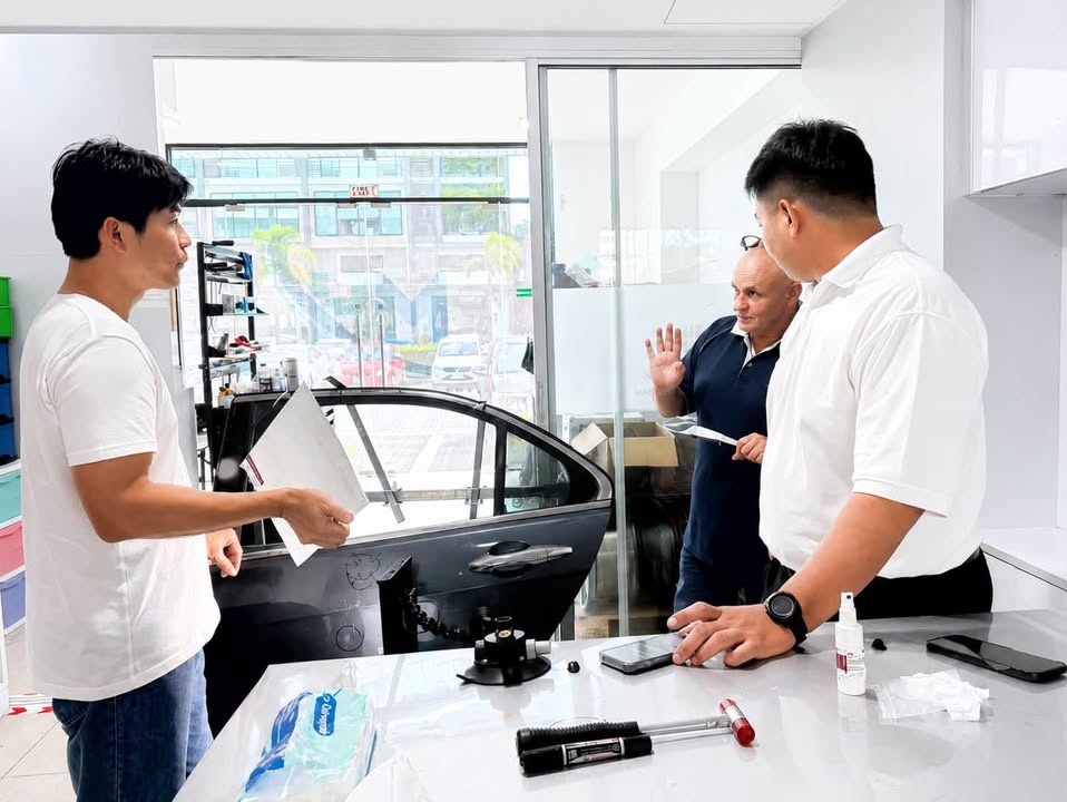 M&H Group trainer explains a PDR repair exercise beside a vehicle door and professional tools - 21 July 2026 Training